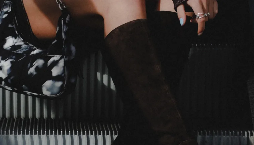 Woman wearing knee high boots on a city street
