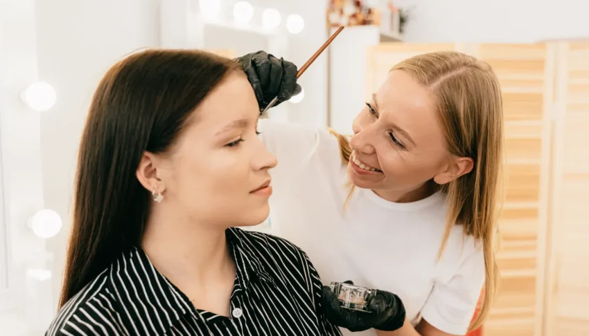 Makeup artist applying eyebrow tint