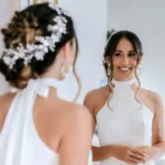 Bride in wedding dress looking in mirror